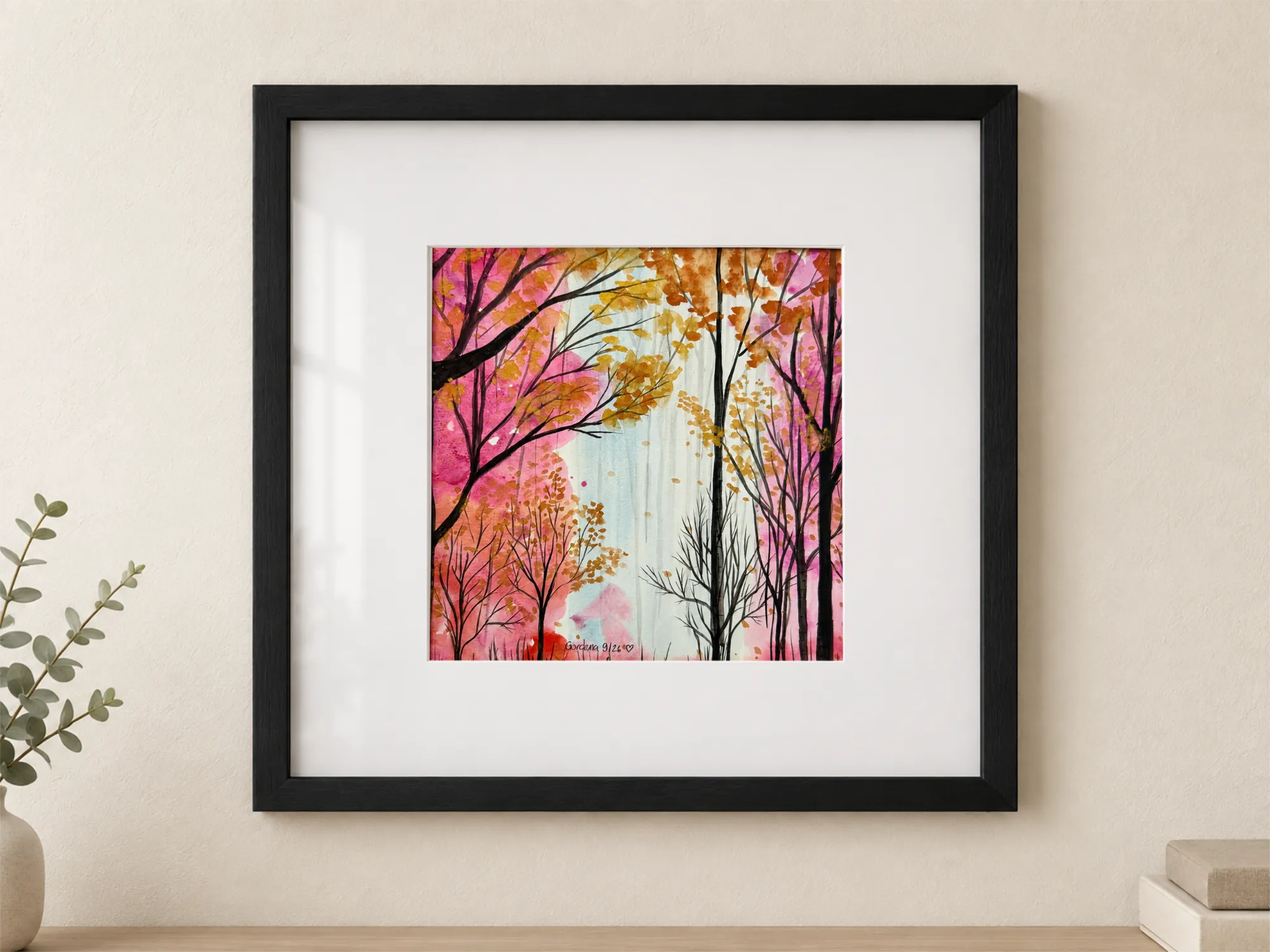 Watercolor and India ink on paper depicting a forest in shades of pink, fuchsia, and golden ochre, with dark trunks and branches, light leaves, and a bright clearing in the background; painting 29 × 29 cm, with white mat, protective glass, and black frame, external dimensions 54 × 54 cm.