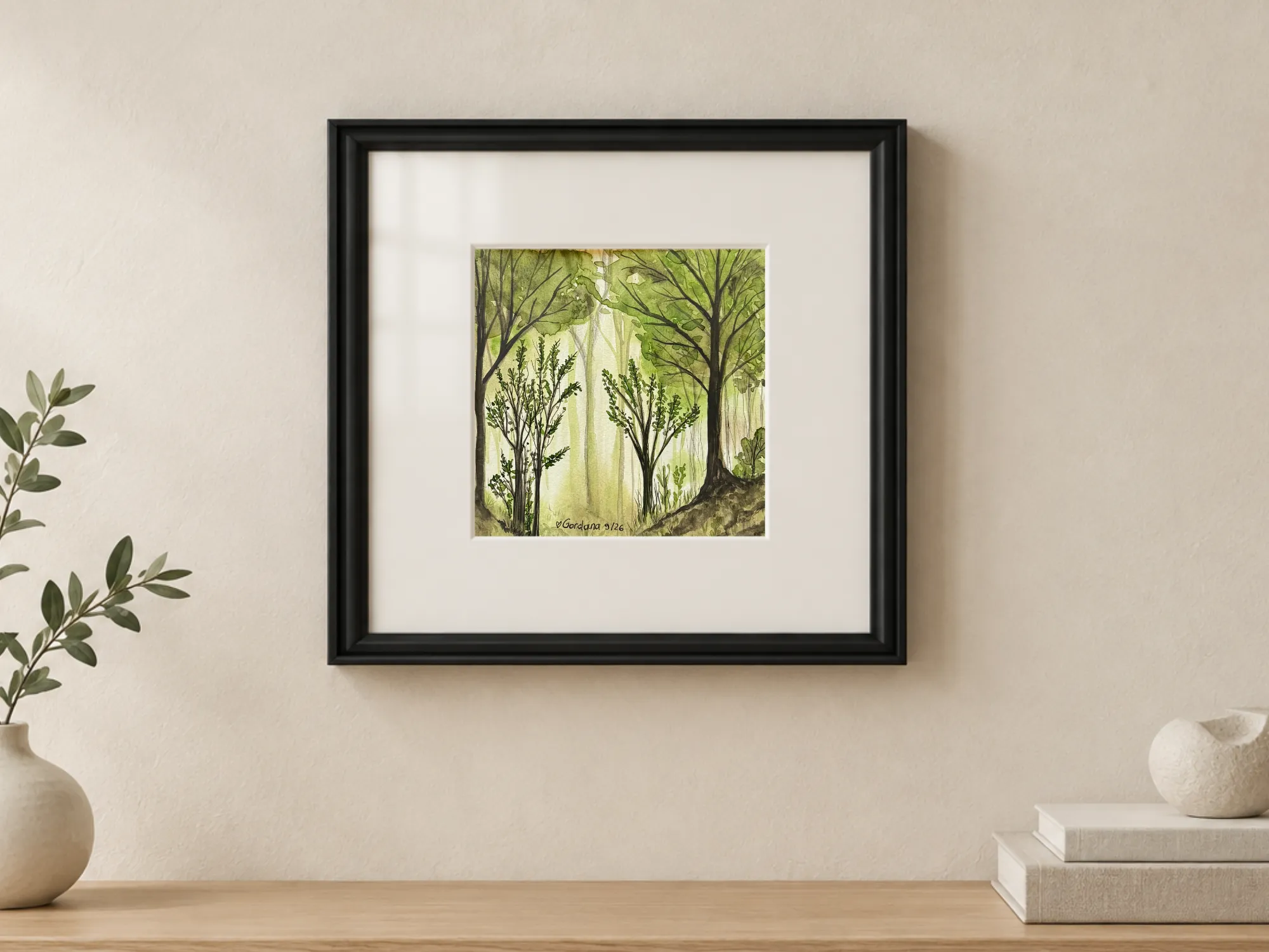 Watercolor and ink on paper depicting a luminous forest in light green and yellow-green tones, with tall trees, bushes in the foreground and light filtering through the trunks; painting 19.5 × 19.5 cm, with white mat, protective glass and black grooved frame, outer dimensions 38 × 38 cm.